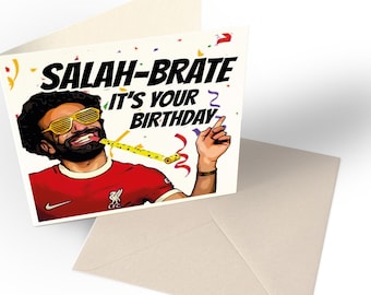 May include: A birthday card featuring a cartoon illustration of a soccer player wearing a red jersey with a yellow party blower. The text on the card reads "Salah-brate It's Your Birthday".