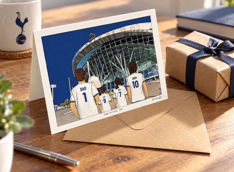 May include: A greeting card featuring a colorful illustration of four people wearing white soccer jerseys with blue trim, standing before a large stadium. The jerseys are labeled DAD 1, LEO 9, MIA 7, and MUM 10. The text Happy Birthday, Dad is printed below.