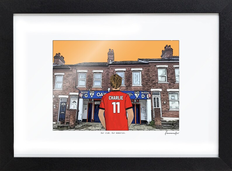 May include: A framed illustration of a person wearing a red jersey with the name CHARLIE and the number 11 on the back, standing before a brick building with blue signage labeled OAK, GATES F G and D E, under an orange sky.