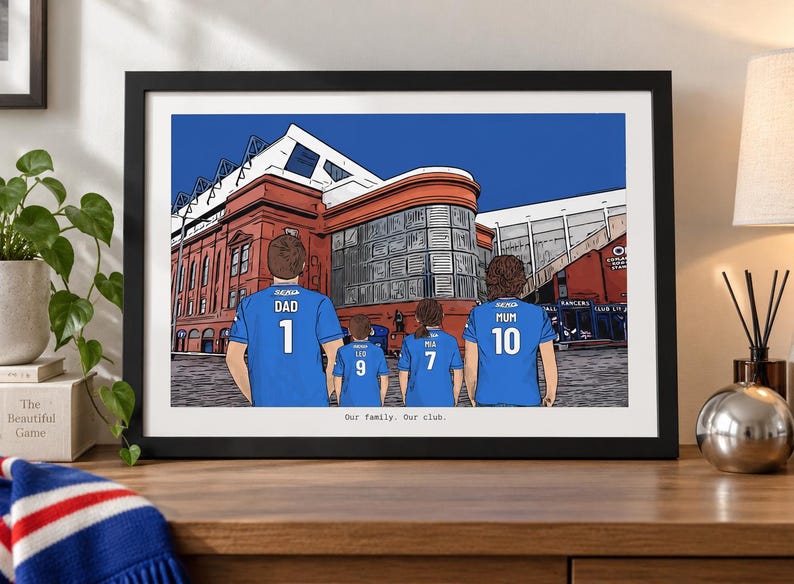 May include: A framed digital illustration of a family of four standing before a large red brick stadium. The family members wear blue soccer jerseys with names and numbers on the back. The text "Our family. Our club." is printed below the image.