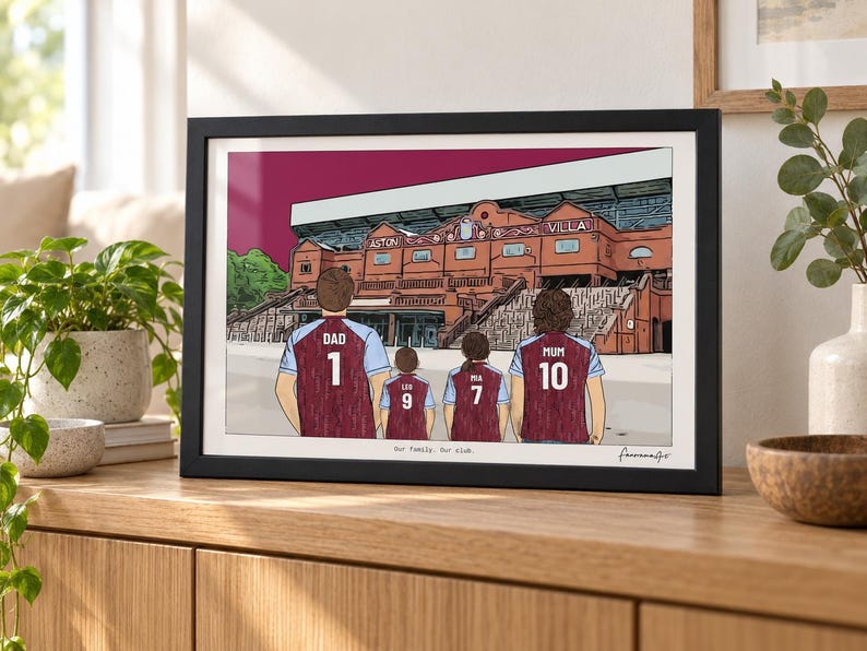 May include: A framed digital illustration of a family of four standing before the Aston Villa stadium. The figures wear claret and blue jerseys with the names DAD, LOU, PIA, and MUM and numbers 1, 9, 7, and 10. The text Our family. Our club. is printed below.