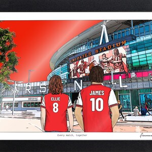 Personalised Arsenal couple print in a black landscape frame, with Ellie 8 and James 10 in red shirts facing the Emirates Stadium.