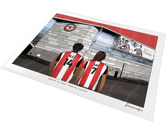 May include: A digital illustration print showing two individuals from behind wearing red and white striped soccer jerseys with the names ALEX 14 and SAM 7, standing before the Gtech Community Stadium with the text Together at Gtech Community Stadium.