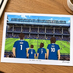 AI-created desk mockup of an unframed Everton A4 family print using the In game background.