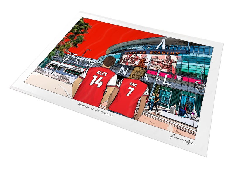 A4 unframed personalised Arsenal print showing Alex 14 and Sam 7 in red shirts facing the Emirates Stadium, displayed at an angle on a white background.