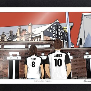 May include: A framed illustration of two people wearing white and black soccer jerseys with the names Ellie and James and numbers 8 and 10, standing before The Fulham Football Club stadium. The text Every match, together is printed at the bottom.