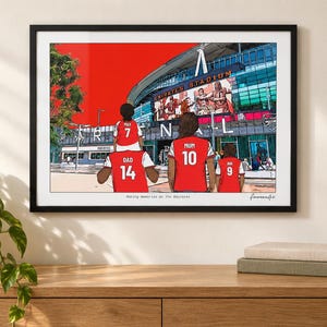 AI-created lifestyle mockup of a black framed Arsenal family print above a wooden console in a bright living room, with a plant and books.
