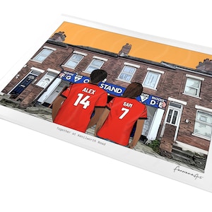 May include: A digital illustration print featuring two individuals wearing red jerseys with the names ALEX 14 and SAM 7 on the back, standing before a brick building with a blue sign labeled BLOCKS GATE F G 6 and BLOCKS GATE D E. The text Together at Kenilworth Road is printed below.