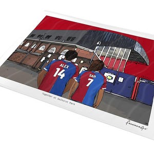 May include: A digital illustration print featuring two individuals wearing red and blue football shirts with the names ALEX 14 and SAM 7 on the back, standing before a stadium exterior. The text reads Together at Selhurst Park and fanoramaArt.