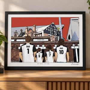 May include: A framed illustration of a family of four wearing white and black soccer jerseys with names and numbers, standing before the Fulham Football Club stadium. The text reads The Fulham Football Club, Our family. Our club.