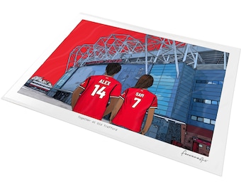 May include: A digital illustration print featuring two figures in red soccer jerseys with the names ALEX 14 and SAM 7, standing before the Old Trafford stadium. The text Together at Old Trafford is printed below the figures on a white background.