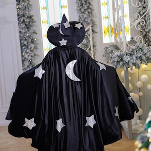 Enchanting Adult Black Wizard Halloween Costume Set: Cape, Hat, and Magic Wand.