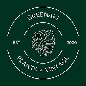May include: A dark green circular logo with white text and a white outline of a monstera leaf. The text reads "GREENARI" at the top, "PLANTS + VINTAGE" at the bottom, and "EST 2020" on the sides.
