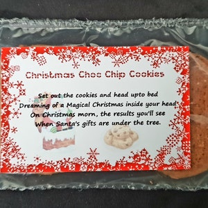May include: A clear plastic bag containing two chocolate chip cookies with a red and white label that reads "Christmas Choc Chip Cookies" and a poem about dreaming of a magical Christmas.