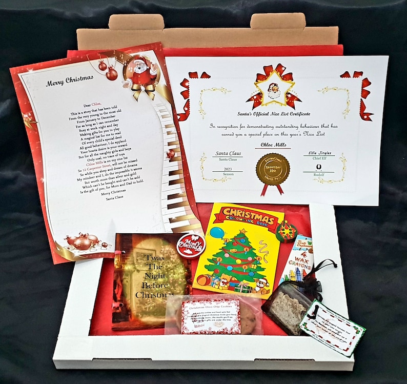May include: A red and white Christmas gift box with a letter, certificate, coloring book, crayons, and cookies. The certificate reads "Santa's Official Nice List Certificate" and is addressed to Chloe Mills. The letter is a personalized letter from Santa Claus.