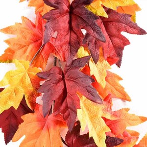Puede incluir: Guirnalda de hojas de otoño artificiales en tonos rojos, naranjas y amarillos. Las hojas están dispuestas en un patrón de guirnalda o vid, perfectas para decoraciones de temporada.