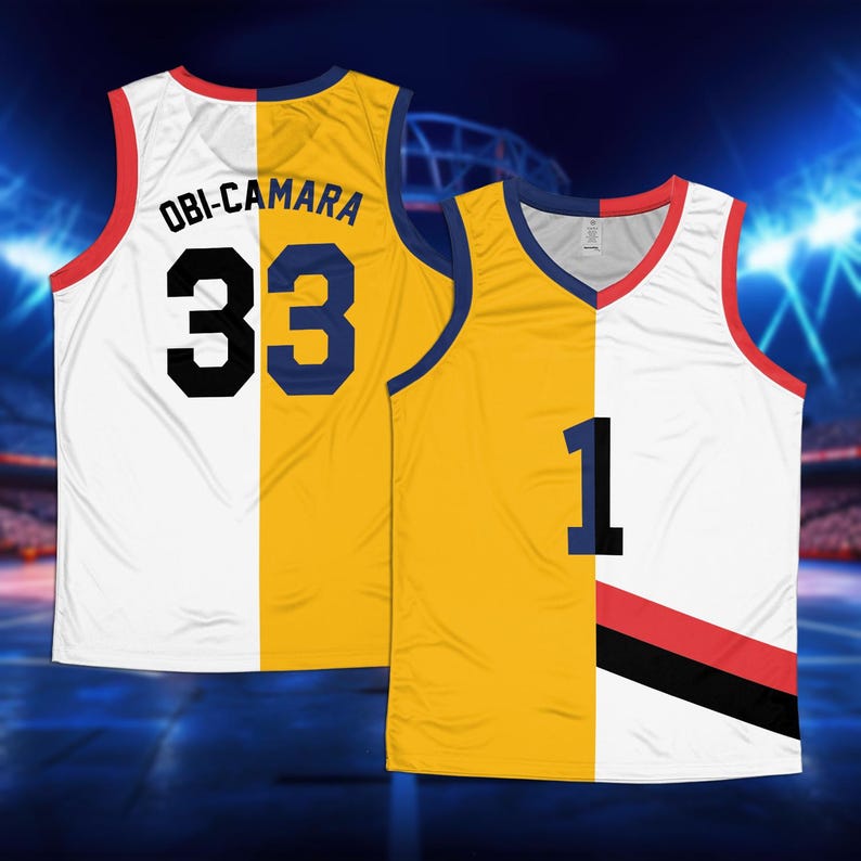 May include: A white and yellow basketball jersey with the name "OBI-CAMARA" and the number "33" on the back. The jersey is split down the middle, with the left side being white and the right side being yellow. The jersey has a red and black stripe on the front.