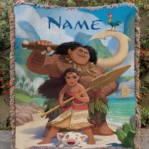 May include: A woven throw blanket with a design from a popular animated film. The image features a large figure with a weapon, a woman with a paddle, and a small pig. The word "NAME" is written across the top in blue.