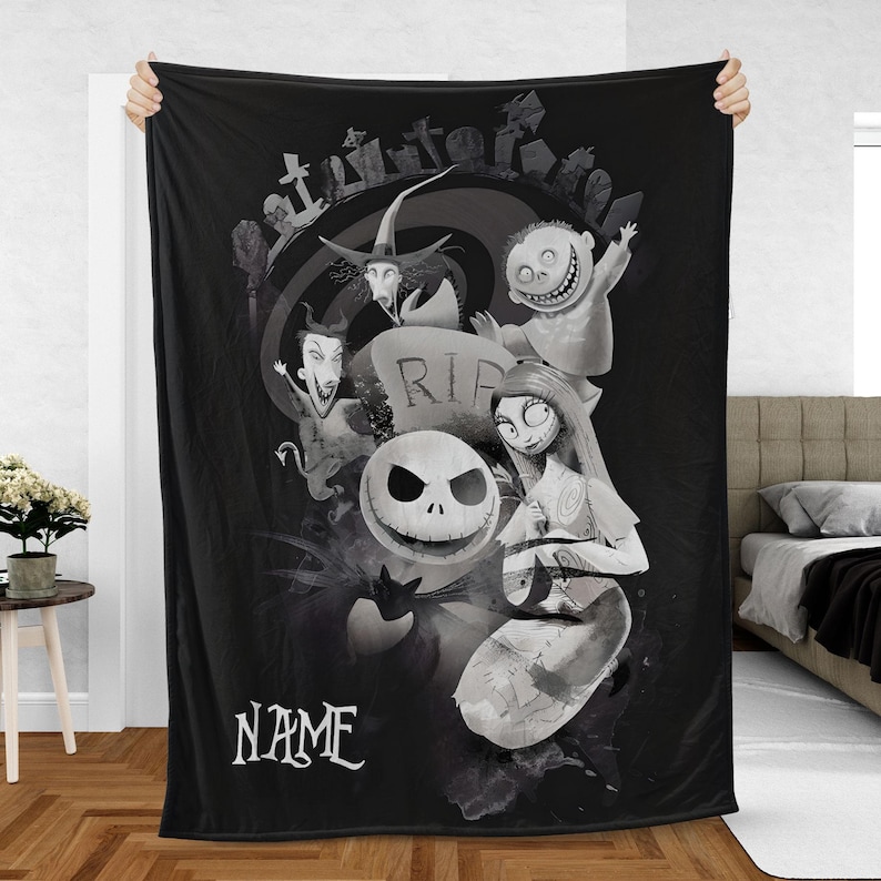 May include: Black and white throw blanket featuring characters from The Nightmare Before Christmas. The design includes Jack Skellington, Sally, and other characters, with a graveyard scene and the word "NAME" at the bottom.