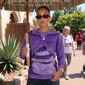 May include: A purple long-sleeve faux fur shrug worn over a purple glittery top with a double-strand pearl belt. The text AVAILABLE SIZES FOR KID/YOUTH/ADULT is visible at the top. The garment features a round neckline and a solid purple hem.