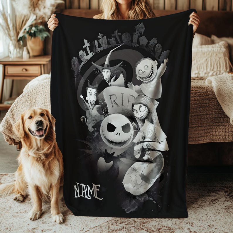 May include: Black throw blanket featuring characters from The Nightmare Before Christmas. The design includes Jack Skellington, Sally, and other characters in a grayscale color scheme. The word "NAME" is at the bottom. A golden retriever dog is in the foreground.