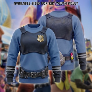 May include: A blue crewneck sweatshirt featuring a printed graphic of a black tactical vest with a gold police badge, a utility belt with pouches, and dark gray sleeve stripes. The text AVAILABLE SIZES FOR KID/YOUTH/ADULT is printed at the top.