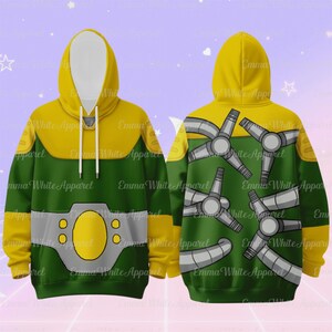 Puede incluir: Una sudadera con capucha verde y amarilla con un dise&ntilde;o en la parte delantera y trasera. La parte delantera presenta un pecho y una capucha amarillos, un torso verde y un dise&ntilde;o de cintur&oacute;n gris. La parte trasera tiene un fondo verde con un patr&oacute;n de brazos mec&aacute;nicos grises. El texto "Emma White Apparel" est&aacute; impreso en la sudadera.