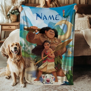 May include: A blue blanket with characters from a popular animated film. The blanket has the word "Name" in blue script. The characters include a large man, a woman holding a spear, a pig, and a rooster. A golden retriever dog is in the foreground.