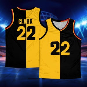 May include: Black and yellow basketball jersey with the name "CLARK" and the number "22" on the back.