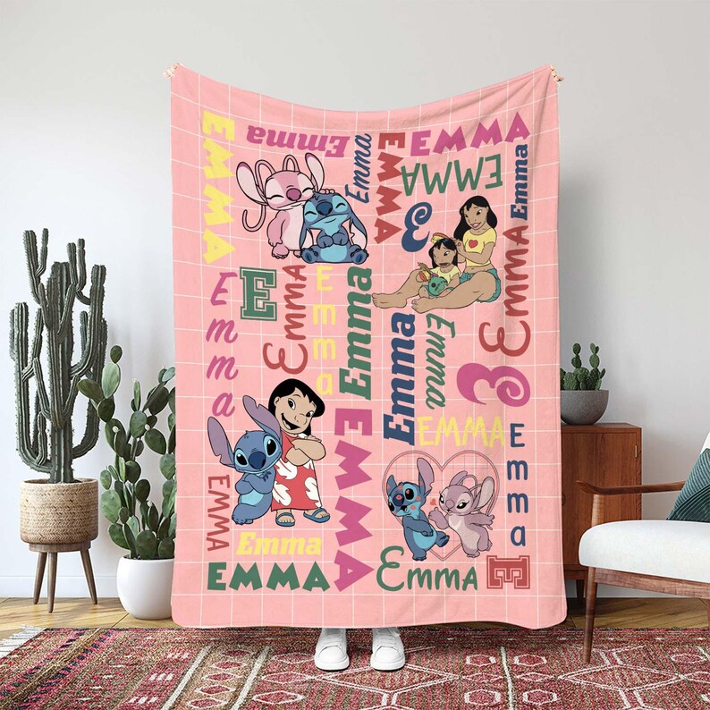 May include: A pink blanket featuring cartoon characters and the name "Emma" in various fonts and colors. The blanket has a grid pattern and includes images of Stitch and Angel.