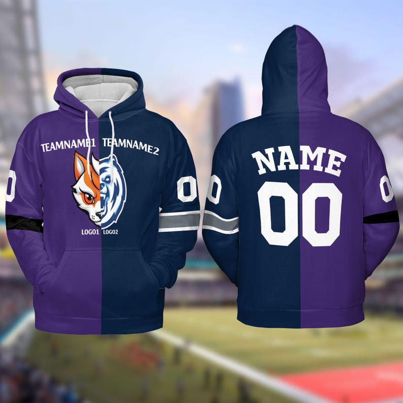 May include: A purple and blue hoodie with a split design. One side features a wolf and fox logo with the text "TEAMNAME1 TEAMNAME2" and "LOGO1 LOGO2". The other side has the text "NAME 00" in white.