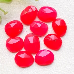 May include: A collection of ten vibrant, hot pink faceted gemstones arranged in a cluster. Each stone features a polished, multi-faceted surface that reflects light, creating a bright, saturated appearance. The text JohariGemsJewels.Etsy.Com is visible.
