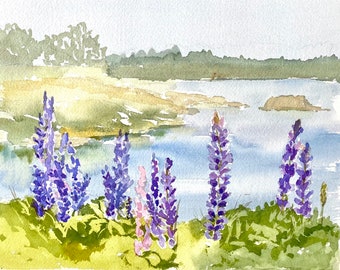 May include: Watercolor painting of a lakeside scene with purple lupine flowers in the foreground. The flowers are in bloom and have a soft, delicate appearance. The lake is a light blue color and the background is a soft green.