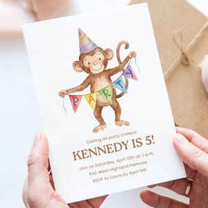May include: A birthday party invitation featuring a watercolor illustration of a brown monkey wearing a party hat and holding a colorful banner that spells out "PARTY". The invitation reads "KENNEDY IS 5!" with event details.