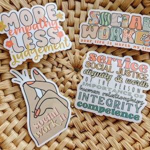 May include: Four colorful stickers with text promoting social work. The first sticker says "More empathy less judgement". The second sticker says "Social Worker your life is worth my time". The third sticker says "Social work it". The fourth sticker says "Service Social Justice dignity & worth of the person importance of human relationships integrity competence".