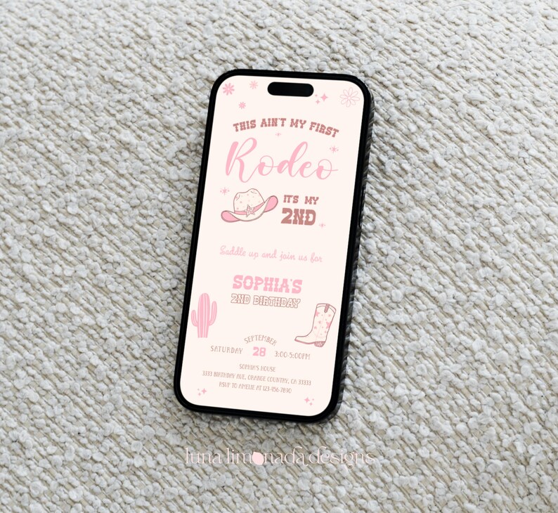 K&ouml;nnte beinhalten: Ein Smartphone mit einer digitalen Einladung in Rosa f&uuml;r einen zweiten Geburtstag. Der Text lautet: This ain't my first rodeo, it's my 2nd, Sophia's 2nd birthday, 28. September, 17:00 Uhr, inklusive Grafiken von Cowboyhut, Kaktus und Stiefel.