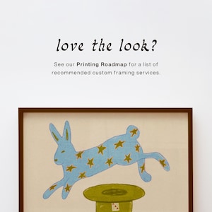 Quirky folk art magic rabbit print framed in a warm bohemian living room with natural textures — whimsical wall decor instant download