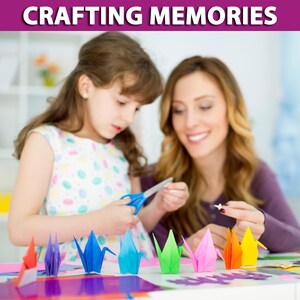 May include: A mother and child are making origami cranes together. They are using colorful paper and scissors. The cranes are arranged in a row on a table.