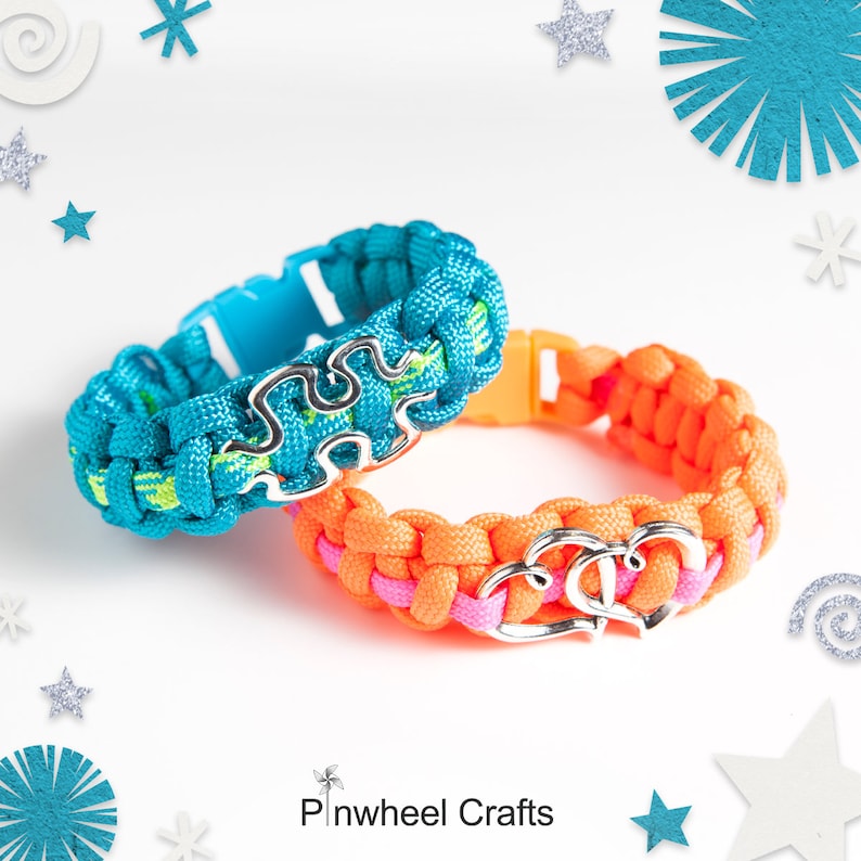 May include: Two friendship bracelets, one turquoise blue with a silver puzzle piece charm and one orange with a silver double heart charm.  Pinwheel Crafts.