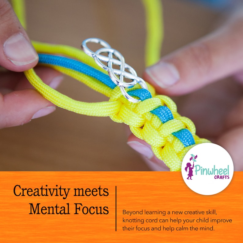 May include: Close-up of a person's hands making a knot with yellow and blue cord. A silver charm in the shape of a knot is attached to the cord. The text "Creativity meets Mental Focus" is visible below the image.