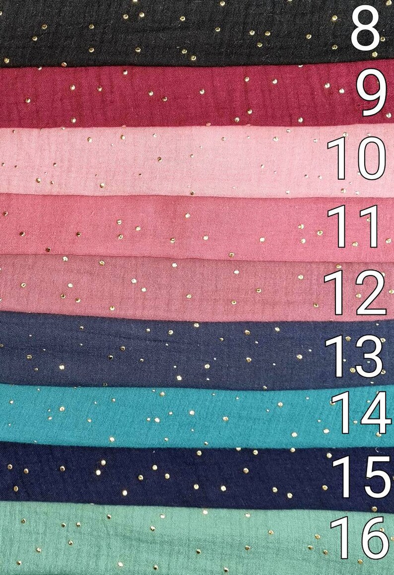 May include: A stack of eight fabric swatches with gold glitter dots. The swatches are in the following colors: black, burgundy, pink, light pink, dark pink, navy blue, teal, navy blue, and light green. The numbers 8 through 16 are printed on the right side of the image.