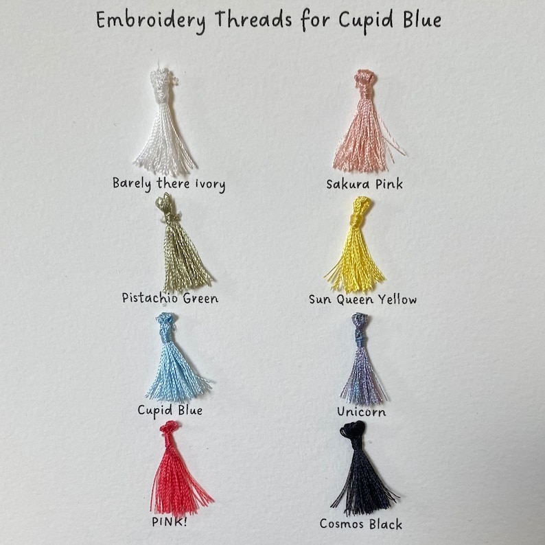May include: Embroidery threads in various colors, including barely there ivory, sakura pink, pistachio green, sun queen yellow, cupid blue, unicorn, pink, and cosmos black. The threads are arranged in a grid on a white background.