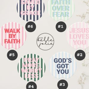 May include: A collection of round car coasters with inspirational phrases like "Faith Over Fear" and "God's Got You." Each coaster features a unique design with stripes and text in various colors, including pink, blue, and green.