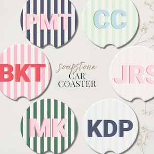 May include: Set of six soapstone car coasters with striped backgrounds in various colors, each featuring a different set of initials in a contrasting color. The text "soapstone CAR COASTER" is in the center.