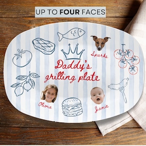 May include: An oval white serving plate with light blue vertical stripes, featuring the text "Daddy's grilling plate" in red, a crown icon, and illustrations of food. It includes two photographic portraits labeled "Olivia" and "Jamie" and a dog labeled "Sparks".
