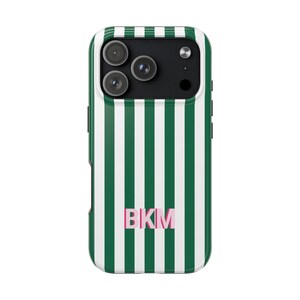 May include: A smartphone case featuring a vertical striped pattern in dark green and white. The back of the case displays the letters BKM in a light pink font centered near the bottom. The camera cutout area is black with three circular lenses.