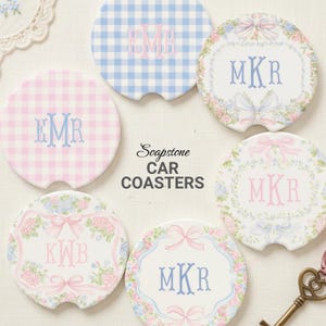May include: A collection of car coasters with personalized monogram designs. The coasters feature floral and gingham patterns in pastel pink and blue. The text "Soapstone CAR COASTERS" is also visible.