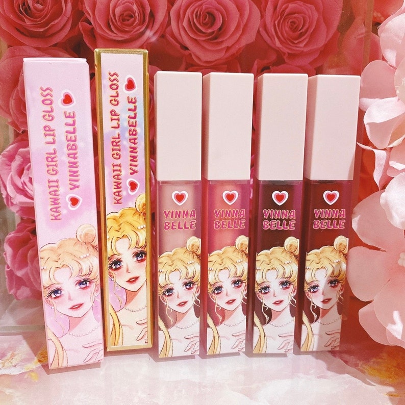 May include: Set of five pink and white lip gloss tubes with a Sailor Moon character design. The tubes have the text "KAWAII GIRL LIP GLOSS VINNABELLE" and "VINNA BELLE" printed on them.