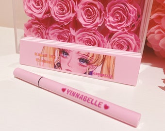 May include: Pink eyeliner pen with the text "Kawaii Girl Eyeliner" and "Yinnabelle" on the packaging. The packaging features an anime-style illustration of a girl with blonde hair.