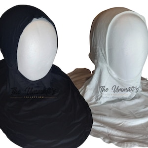 May include: Two under-scarves, one black and one white, with a hole for the face. The text "The Ummaati's Collection" is printed on the black under-scarf. The text "The Ummaati's Collection Where Modesty Meets Elegance" is printed on the white under-scarf.